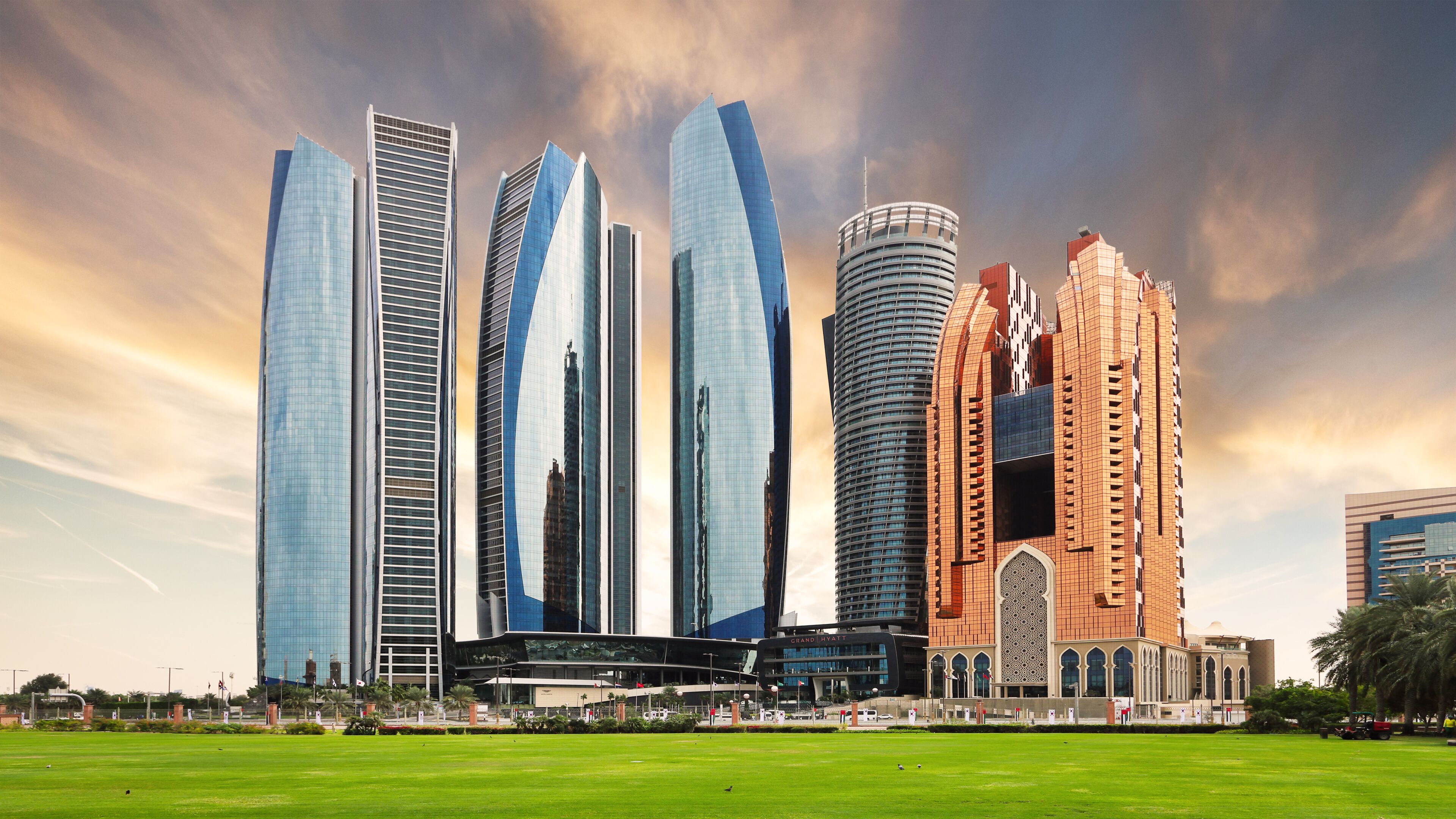 Abu Dhabi skyline at dramatic sunset; United Arab Emirates