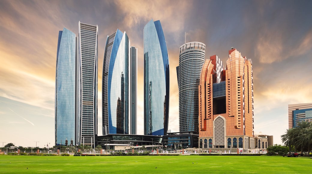 Abu Dhabi skyline at dramatic sunset; United Arab Emirates