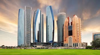 Abu Dhabi skyline at dramatic sunset; United Arab Emirates