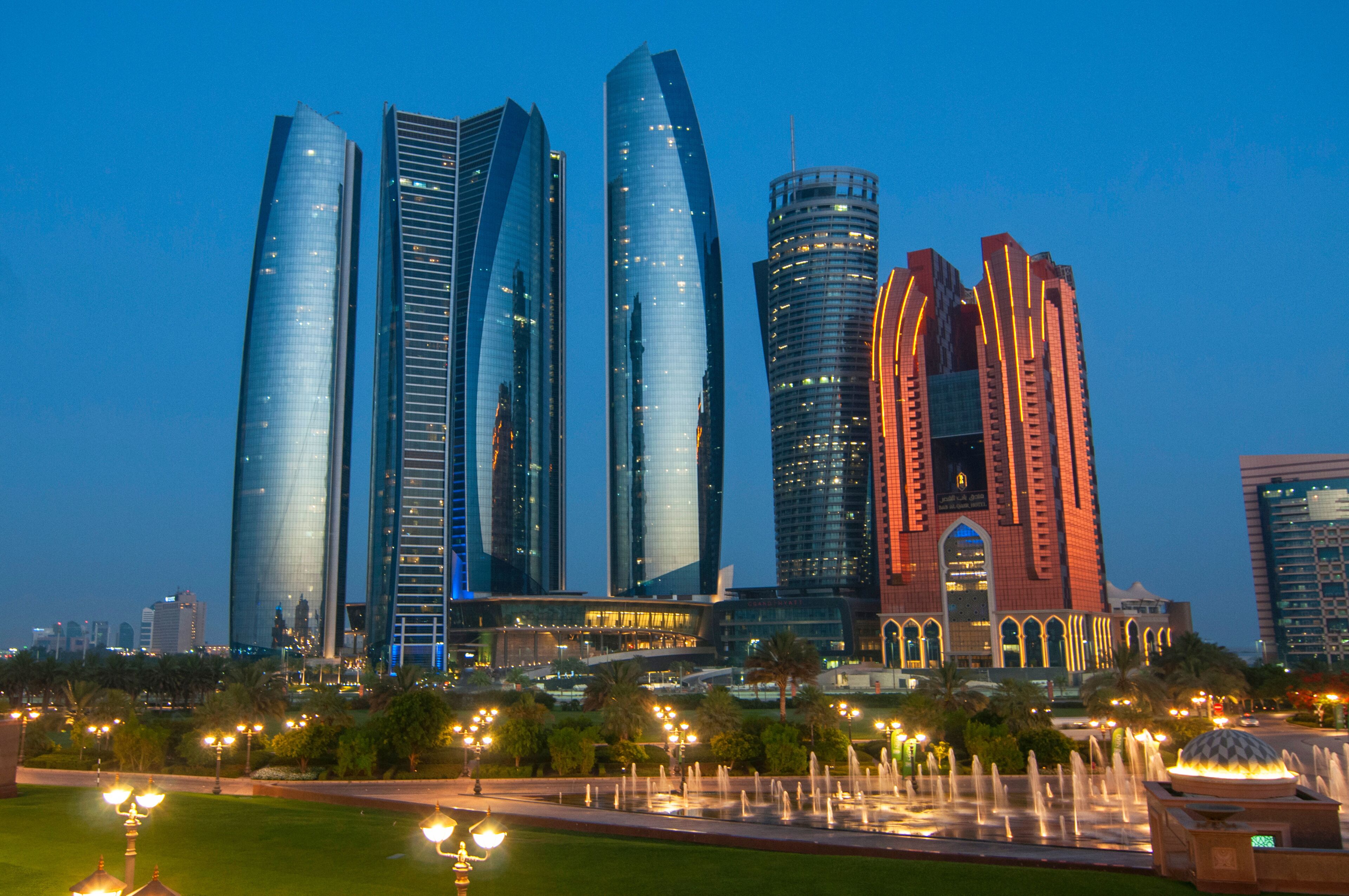 Skyscrapers of Abu Dhabi at night with Etihad Towers buildings. Abu Dhabi is the capital and the second most populous city of the United Arab Emirates.