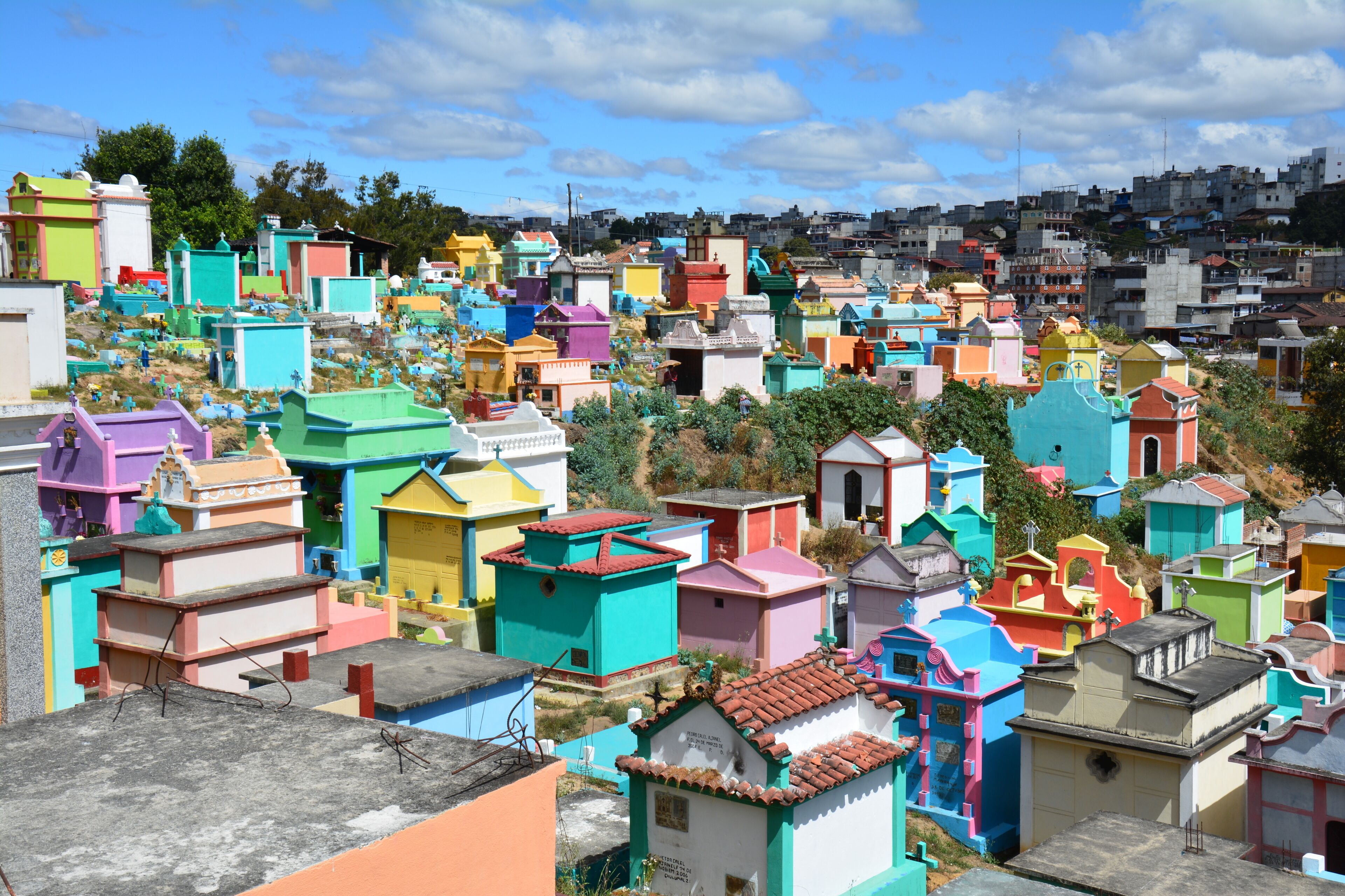 A densely packed hillside with colorful, uniquely shaped buildings.
