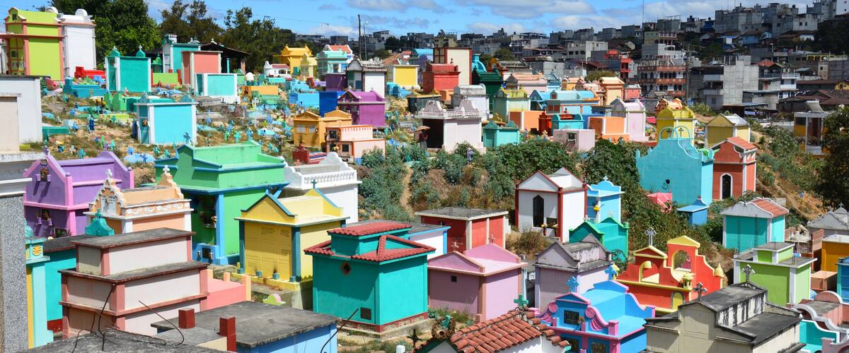 A densely packed hillside with colorful, uniquely shaped buildings.