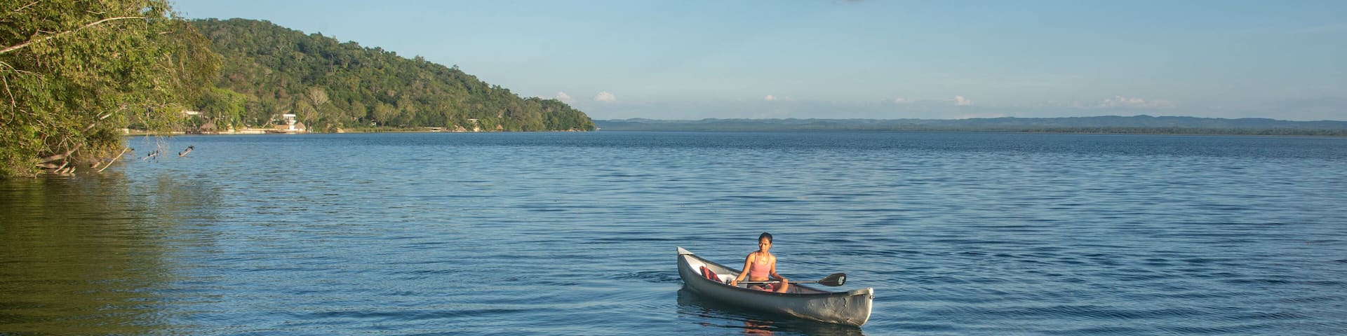 Canoeing on beautiful Lake Peten Itza, El Remate, Petén, Guatemala