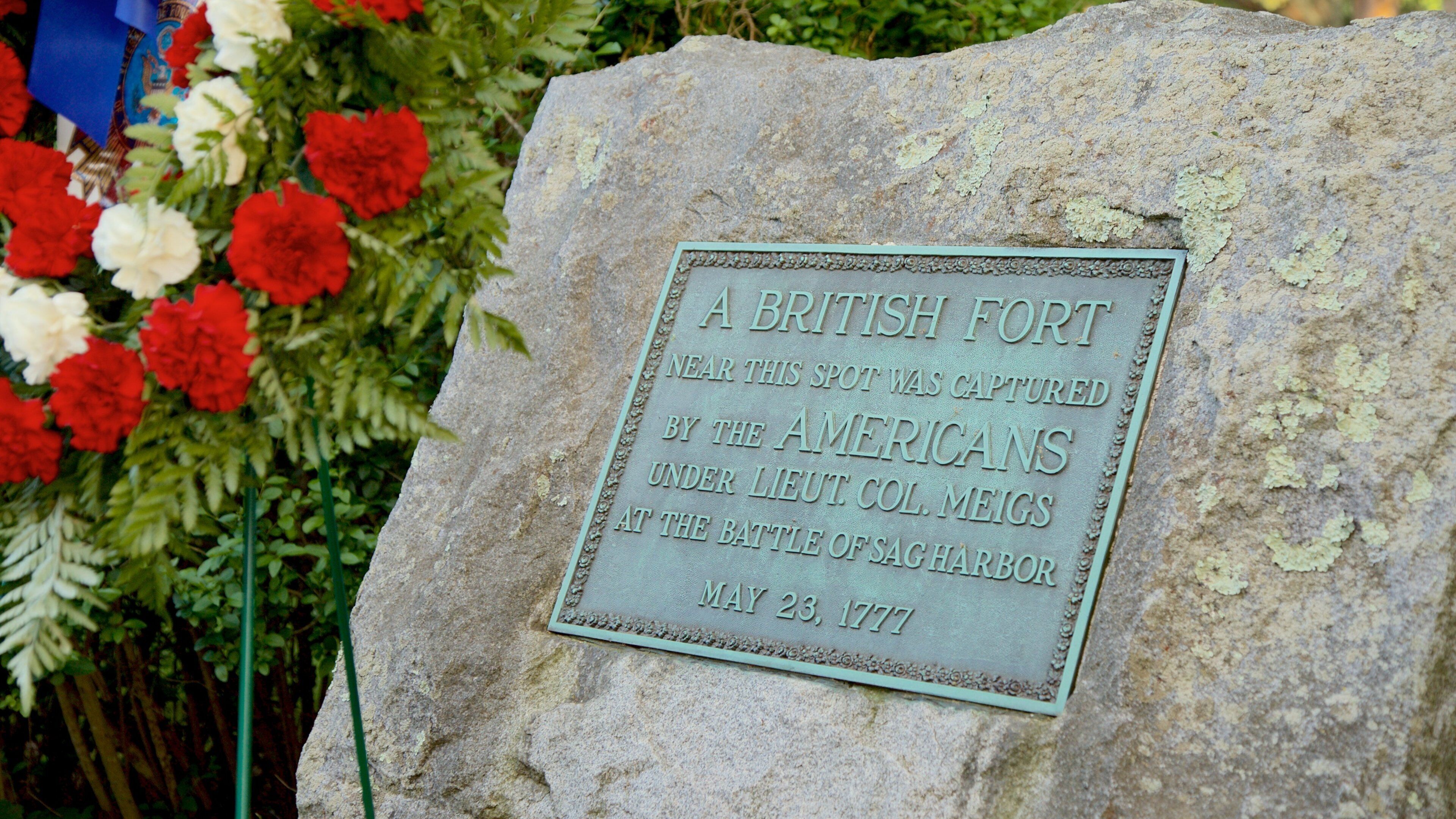 Sag Harbor Old Burying Ground which includes signage and flowers