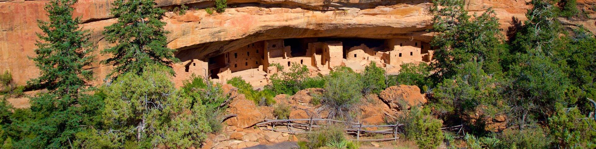 A cliff with ancient cliff dwellings carved into the rock.