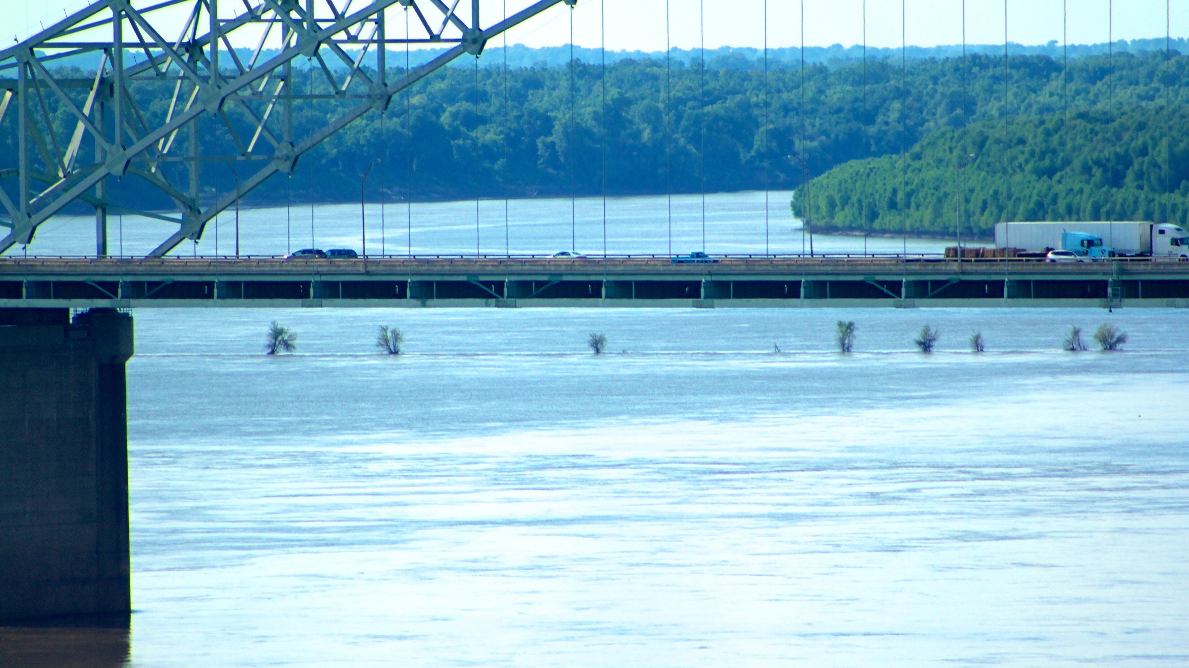 Hernando de Soto Bridge featuring a river or creek and a bridge