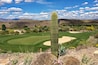 Golf course with undulating greens surrounded by sand traps and cactus in Wickenburg, Arizona