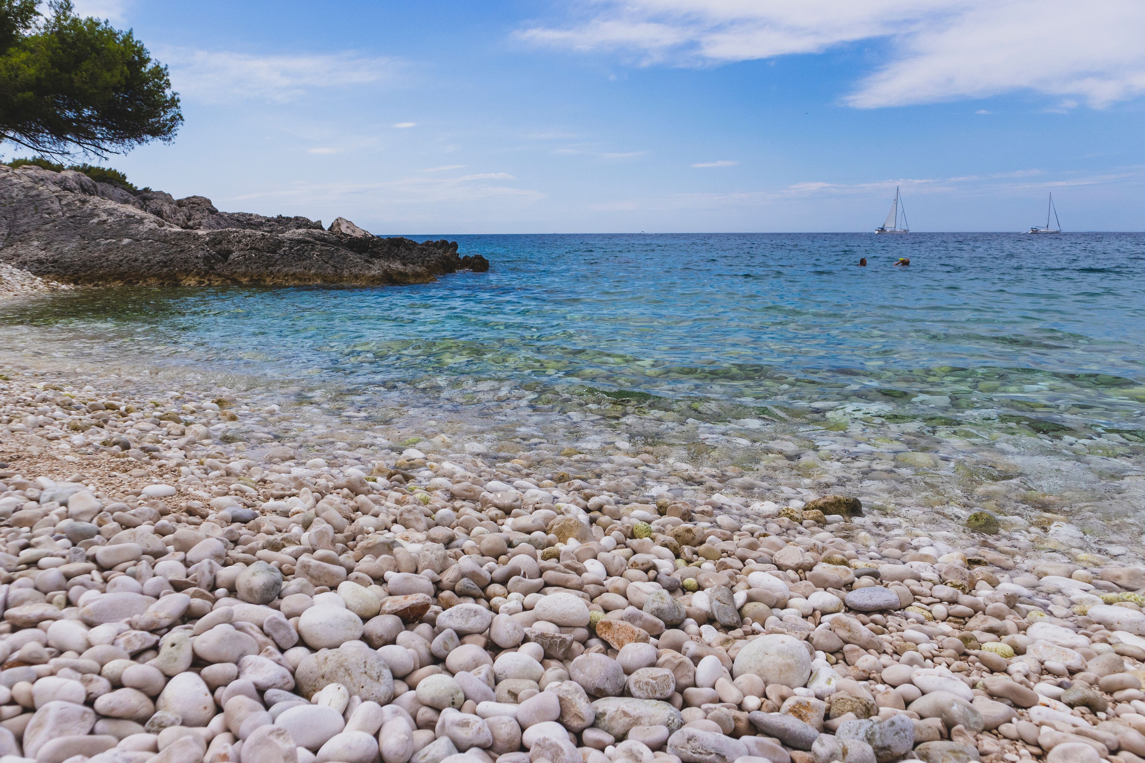 Fascinating blue Adriatic sea splashing white pebble "Mekicevica" beach on the Hvar island, popular nautical tourist destination in Croatia