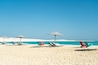 Dream paradise beach with umbrellas and chairs at the turquoise Mediterranean sea at El Alamein near Alexandria, Egypt