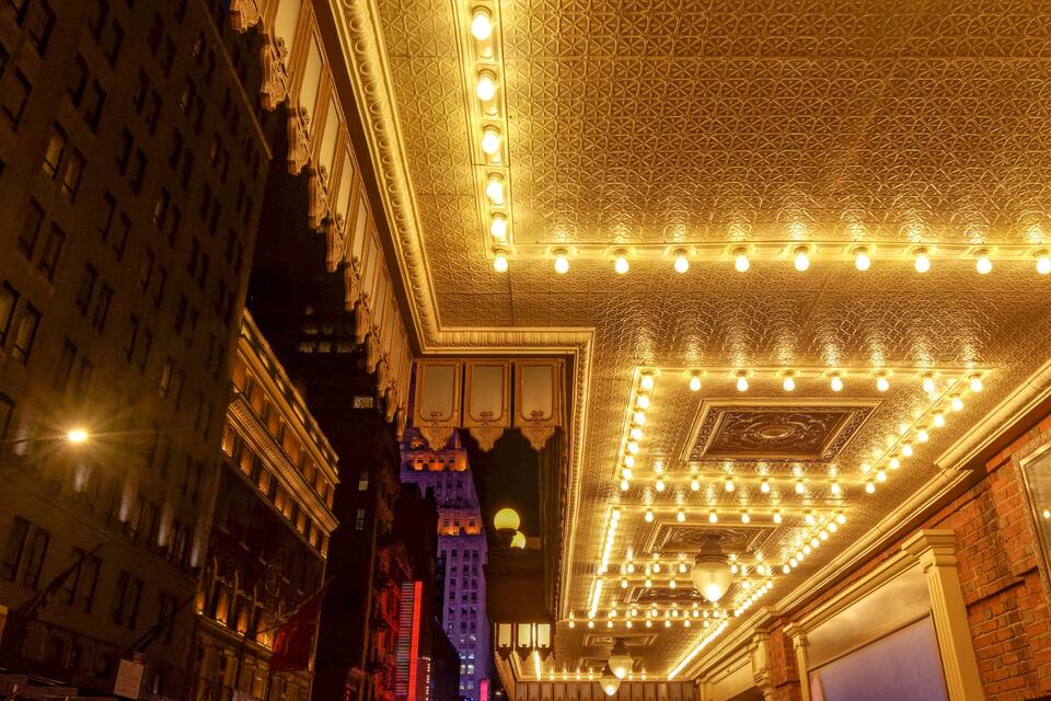 A theater interior with ornate ceiling and lighting fixtures.