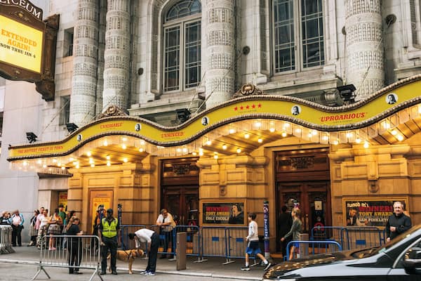 A theater with ornate architecture, including columns and a marquee.