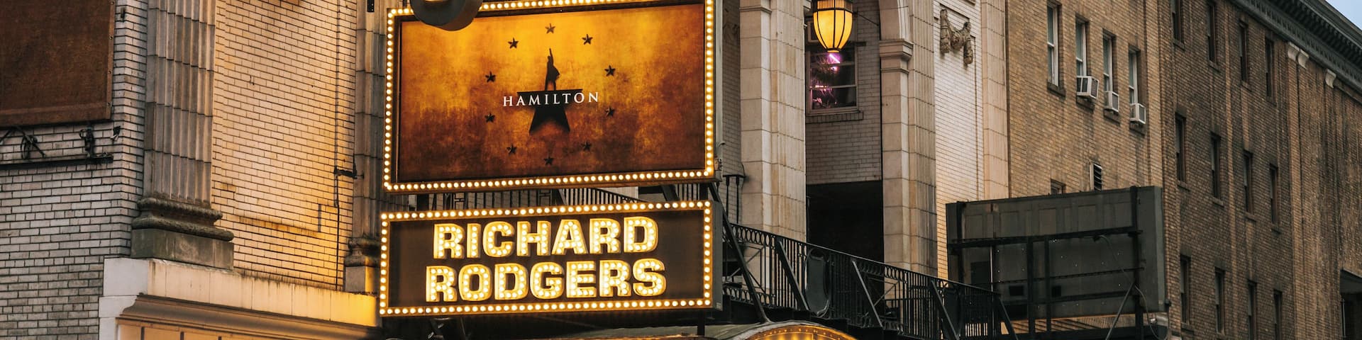 A theater marquee with 'Rodgers' and 'Richard Rodgers' illuminated signs.