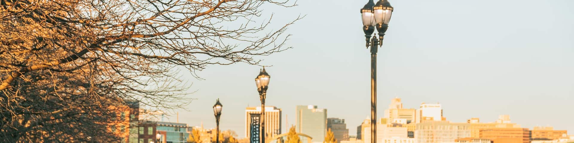 Wilmington Riverwalk featuring a sunset as well as a couple
