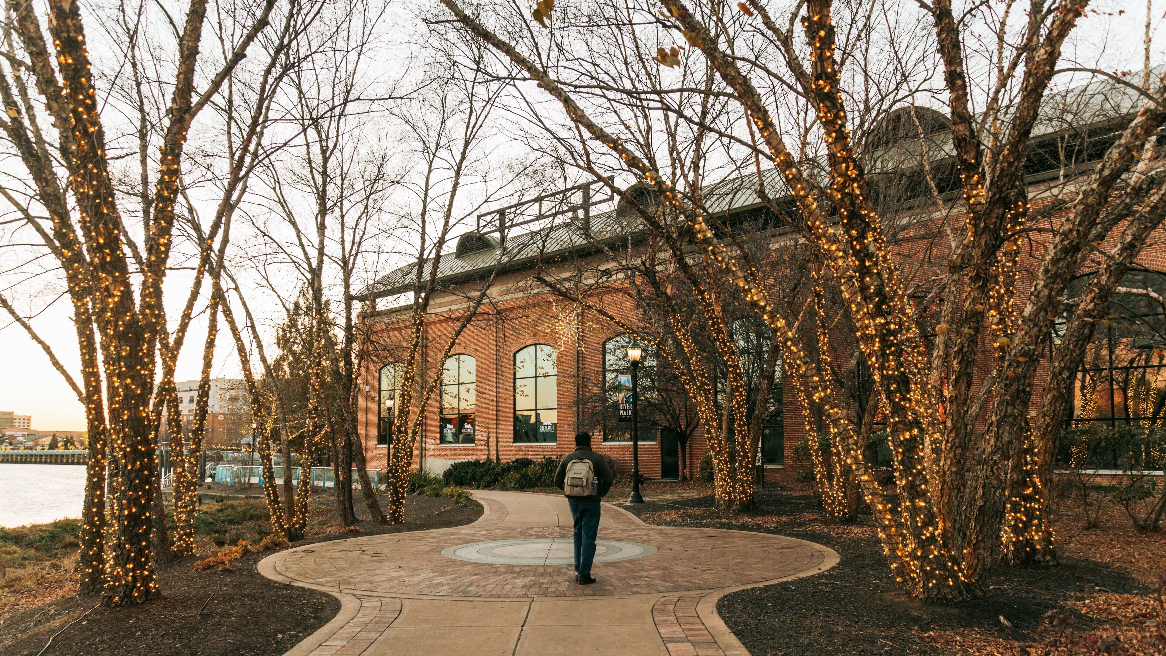 Wilmington Riverwalk showing a park as well as an individual male
