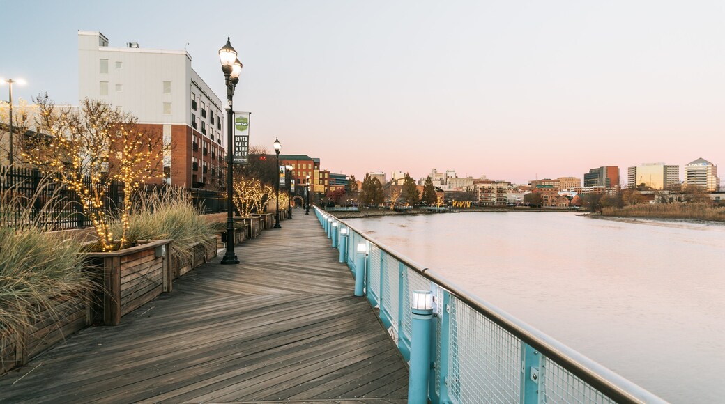 Wilmington Riverwalk which includes a river or creek and a sunset