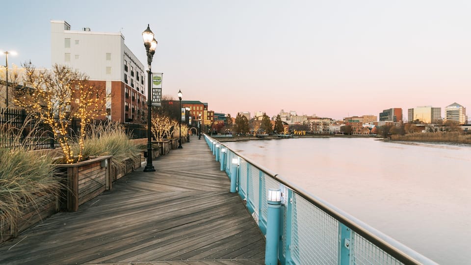 Wilmington Riverwalk which includes a river or creek and a sunset