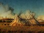 A traditional tipi with a wooden frame and a canvas cover, surrounded by a grassy field and a wooden fence.