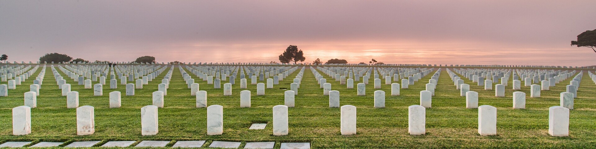 Fort Rosecrans National Cemetery featuring a cemetery and a sunset