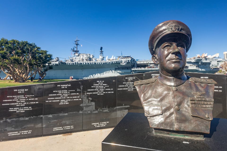 A naval memorial with a bust and a list of names.