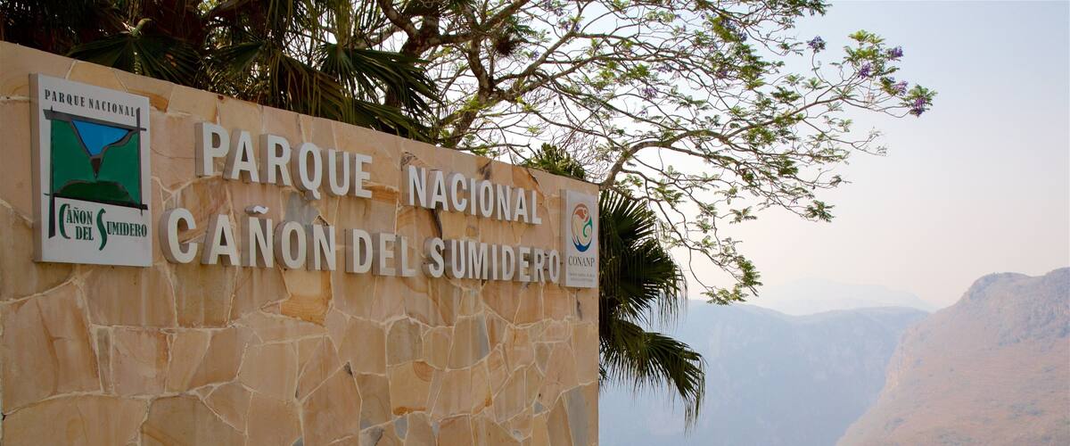 A stone wall with signs for Parque Nacional and Canon del Sumidero.