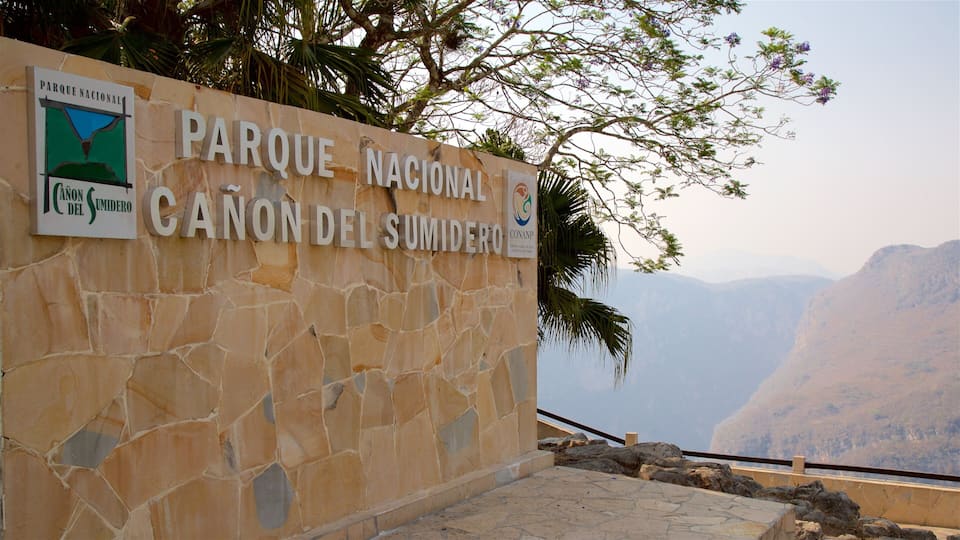 A stone wall with signs for Parque Nacional and Canon del Sumidero.