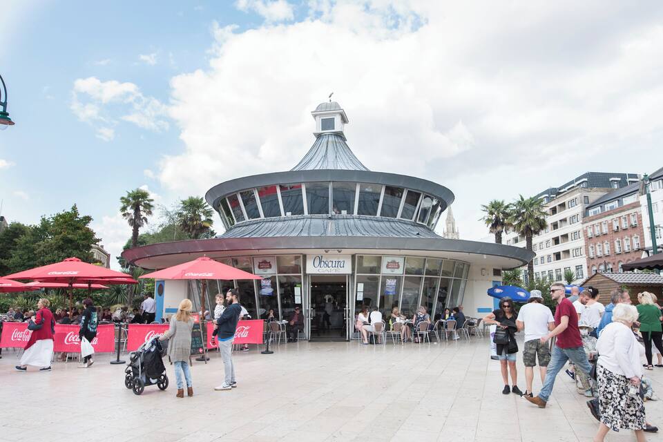 A circular building with a dome and a Coca-Cola sign.