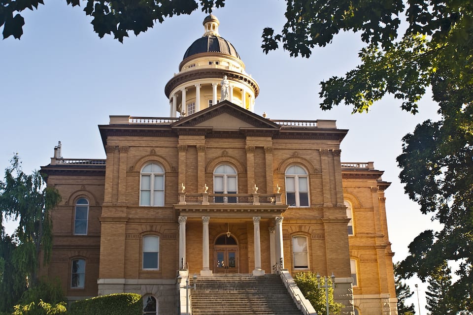 A large brick building with a dome and columns.