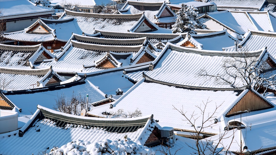 Roof of Jeonju traditional Korean village covered with snow, Jeo