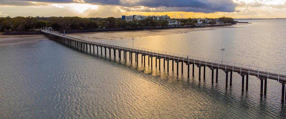 Urangan Pier which includes a bridge, landscape views and general coastal views