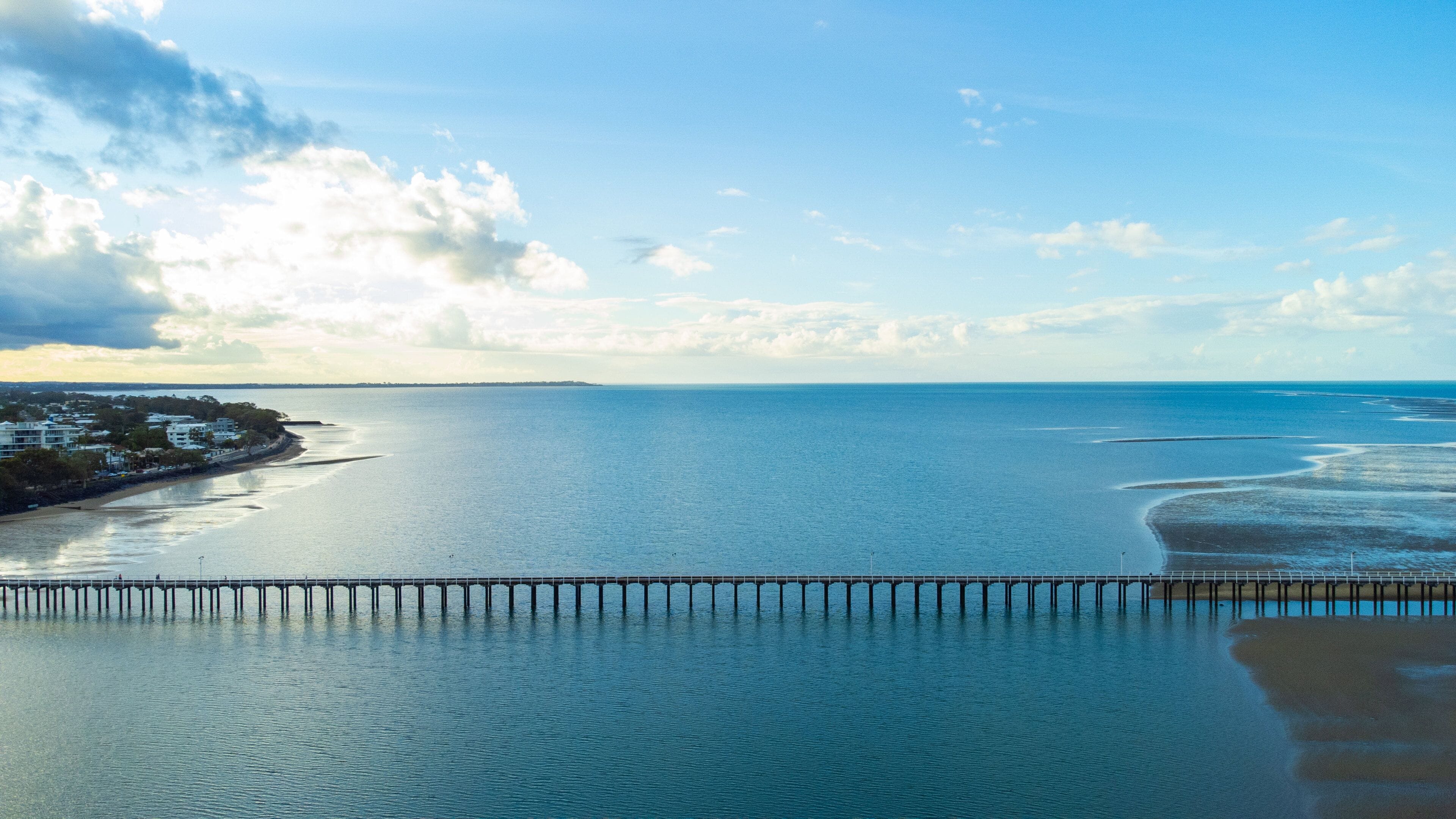 Urangan Pier featuring landscape views, a sunset and general coastal views