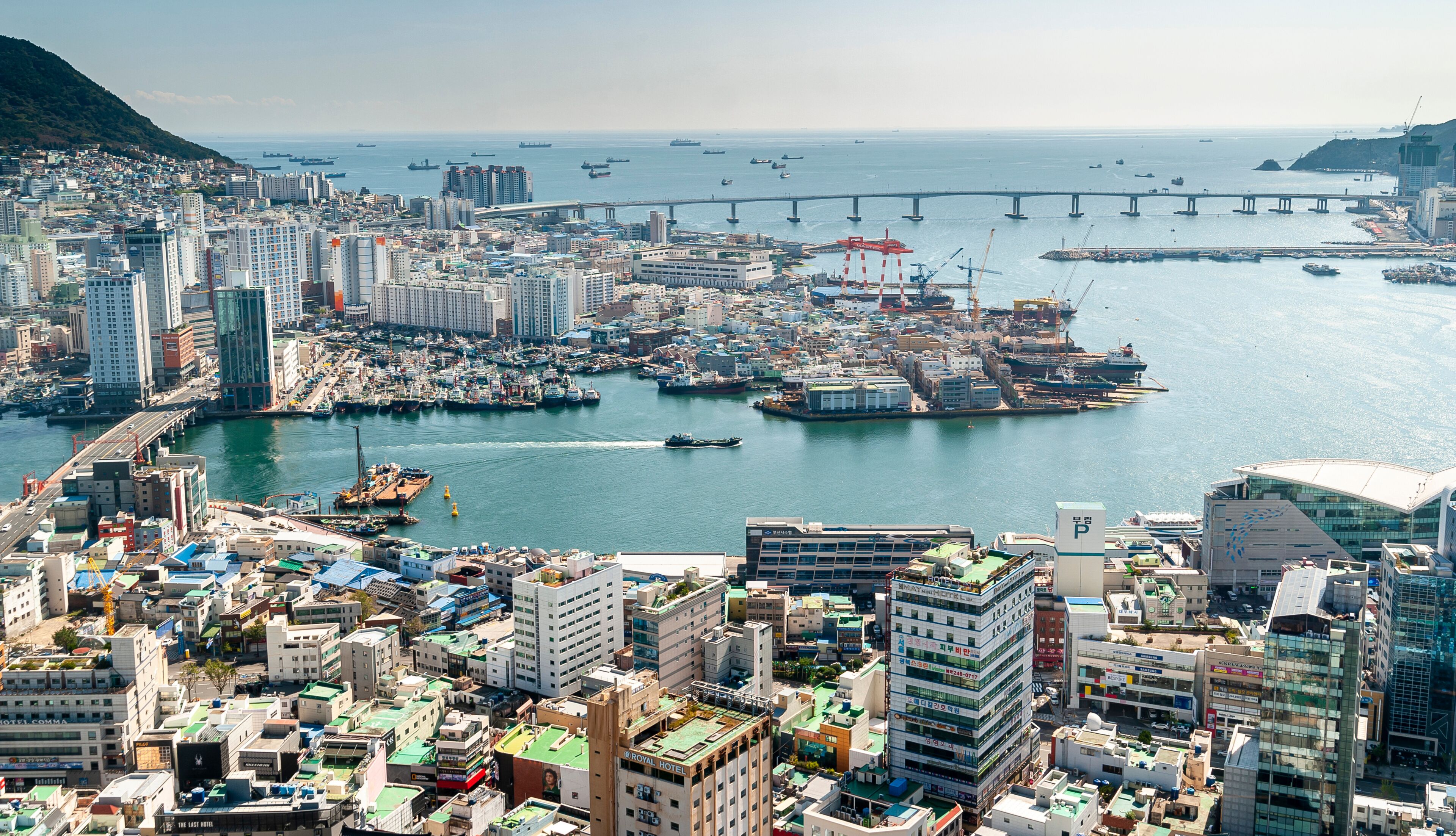 Yeongdo-gu, Busan, South Korea - October 2, 2020: Aerial view of Busan South Port with the background of Yeongdo and Namhangdaegyo Bridge