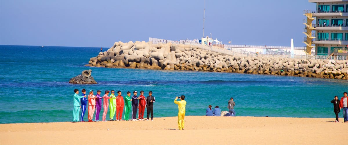 Anmok Beach showing general coastal views and a sandy beach as well as a small group of people