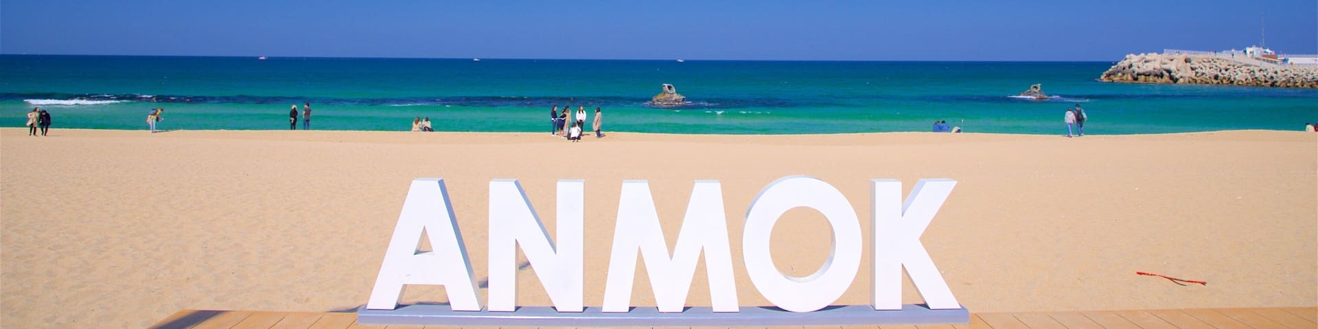 A beach with the word "ANMOK" in large letters.