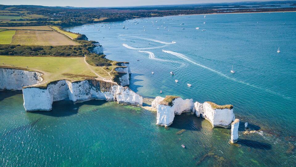 A coastal landscape with cliffs and a clear view of the sea.