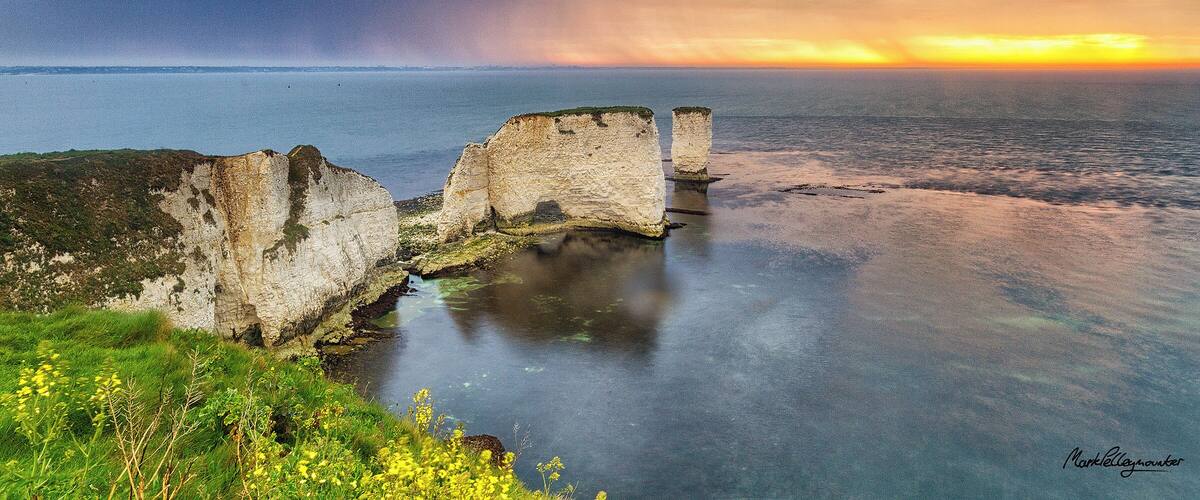 Storm clouds at sunrise over Old Harry Rocks. A chalk sea stack formation near to Studland in a UNESCO World Heritage Site and designated Area of Outstanding Natural Beauty on teh Jurassic Coast in Dorset, UK