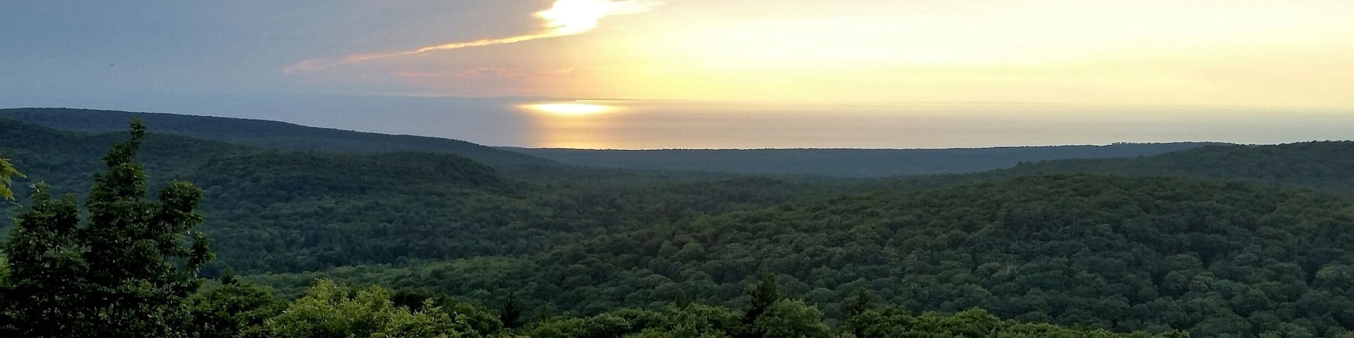 Between the wooden planks of the Summit Peak tower is an incredible view +1958 ft up. A must see just a dozen miles from the Porcupine Mountains visitors center.