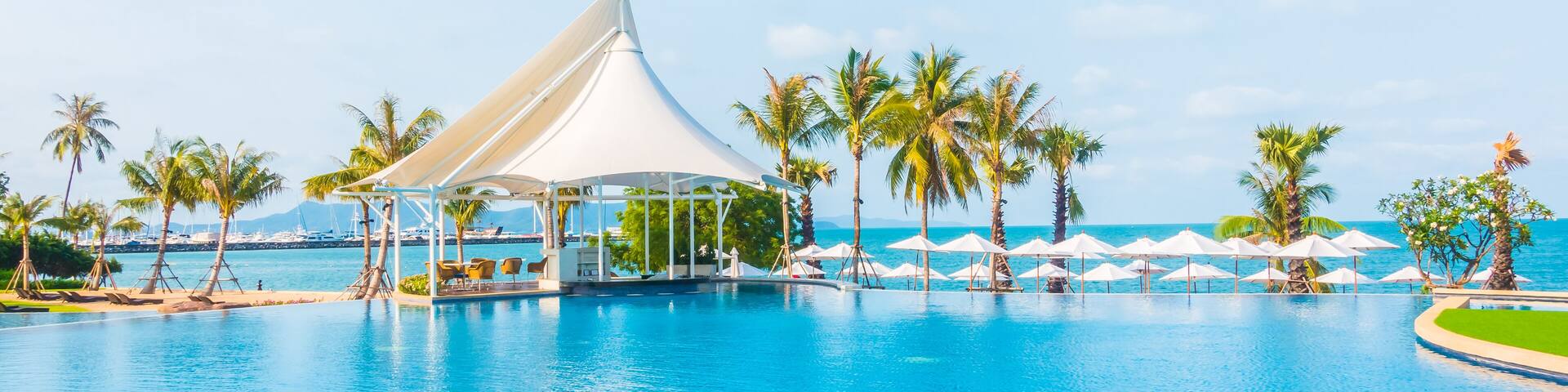 Umbrella and empty chair around swimming pool in hotel resort - Boost up color Processing, Shutterstock ID 396357721, Purchase Order: -