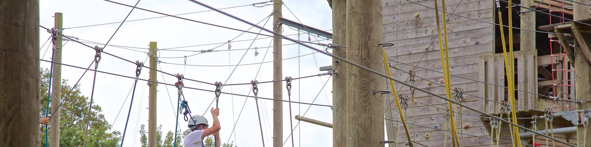 Creepy Valley Adventure Centre showing a suspension bridge or treetop walkway as well as a small group of people