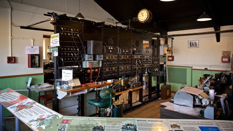 A historical exhibit of early 20th-century communication equipment, including telephones and encryption machines.