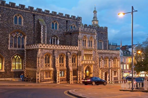 A historic stone building with arched windows and a tower.