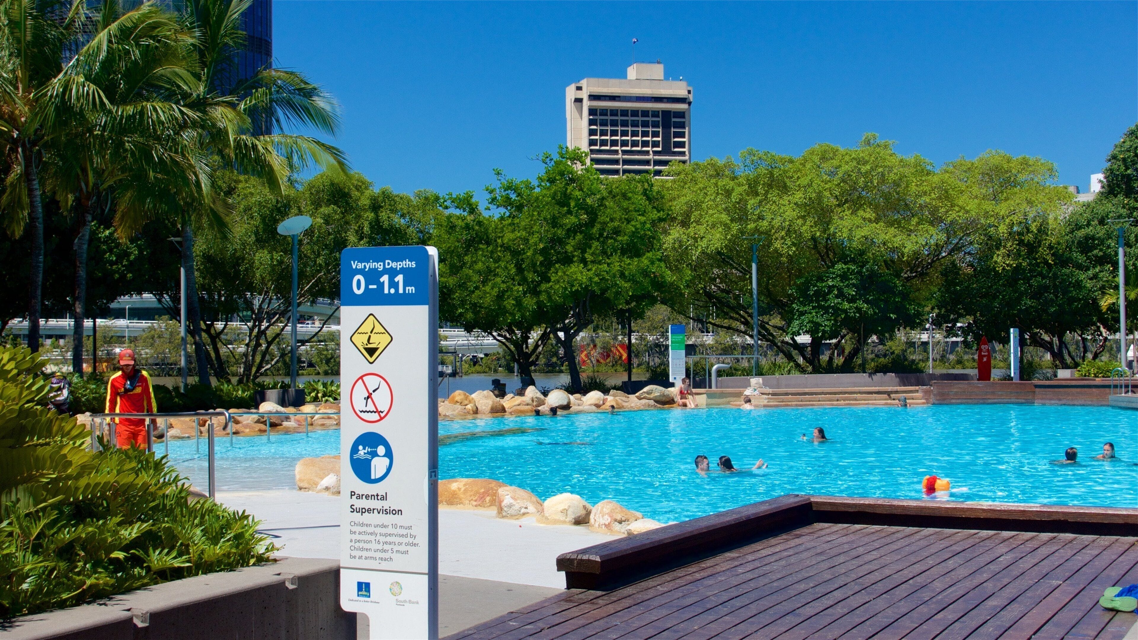 Southbank Parklands which includes a pool, signage and swimming