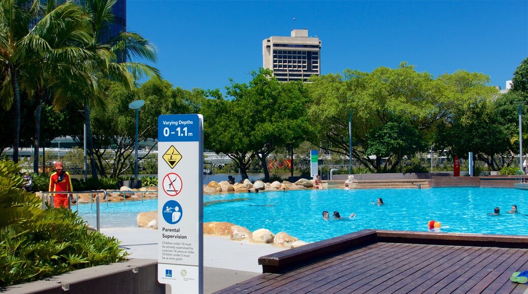 Southbank Parklands which includes a pool, signage and swimming
