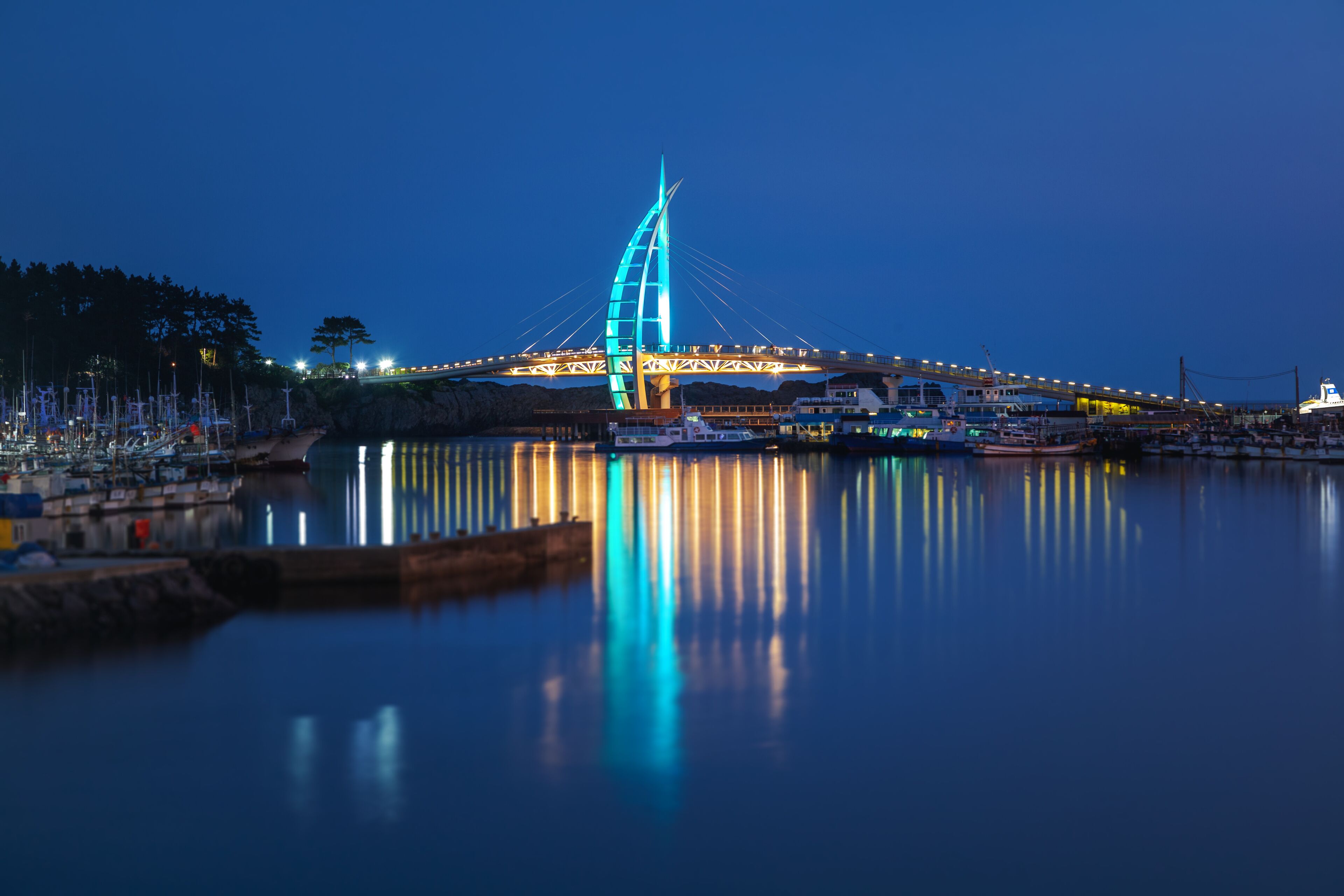 Bright night landscape, bridge in Seogwipo-si  Jeju Island, South Korea. Night illumination, long exposure