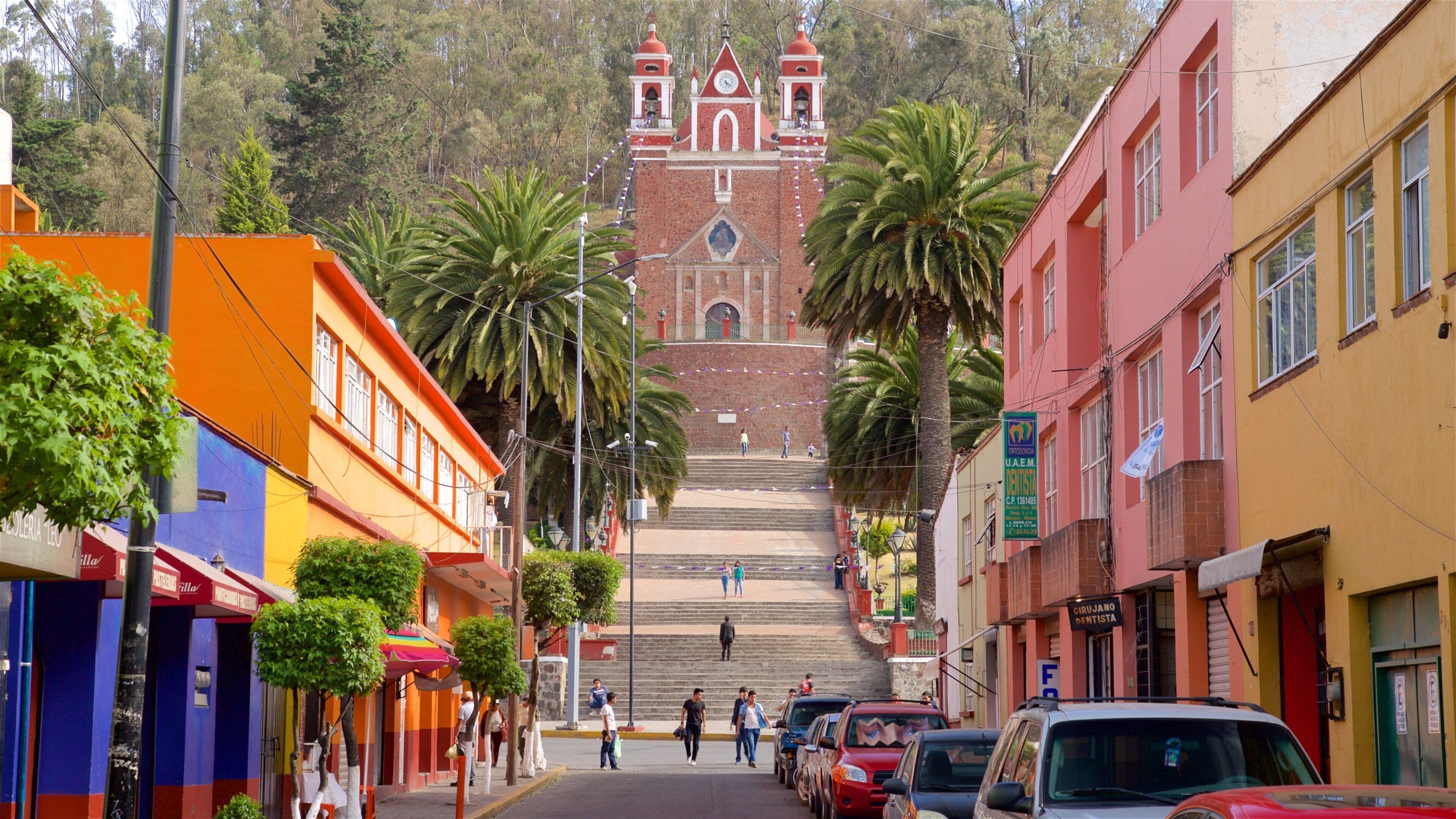 A street leading up to a church with a bell tower.