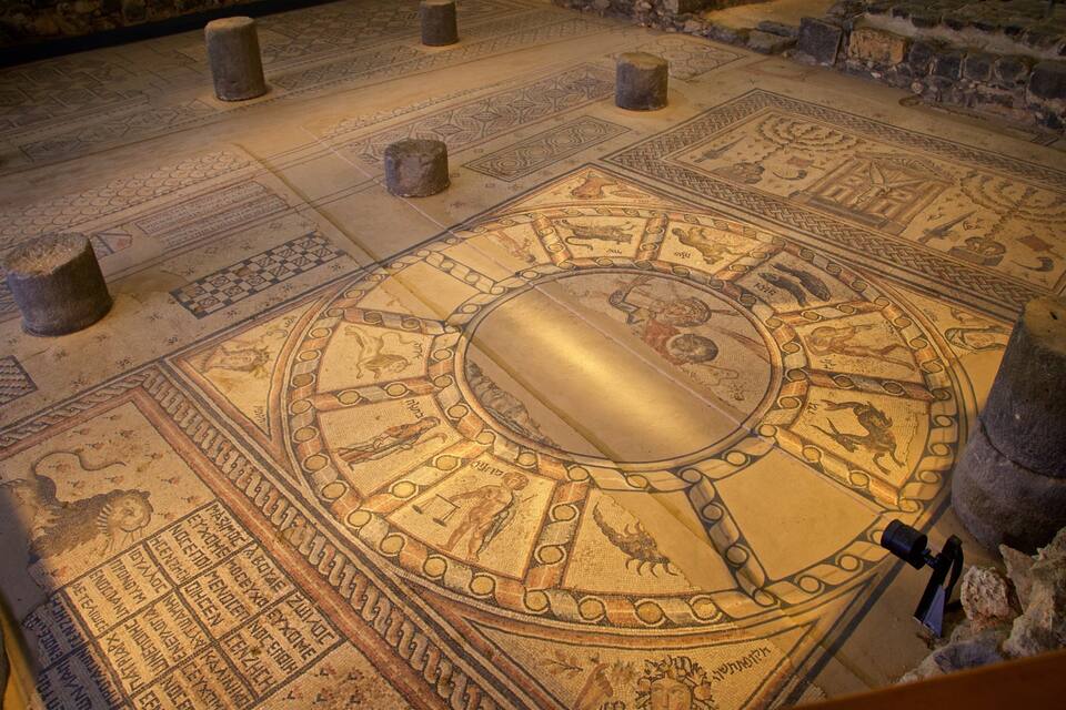Um detalhado chão em mosaico com padrões geométricos e um desenho circular central.