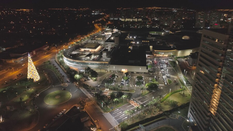 Aerial view at night over Ribeirão Shopping, the largest mall in Ribeirão Preto city, Brazil. December, large Christmas tree. 4K.
