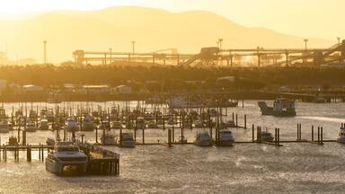 Callemondah which includes a bay or harbor and a sunset