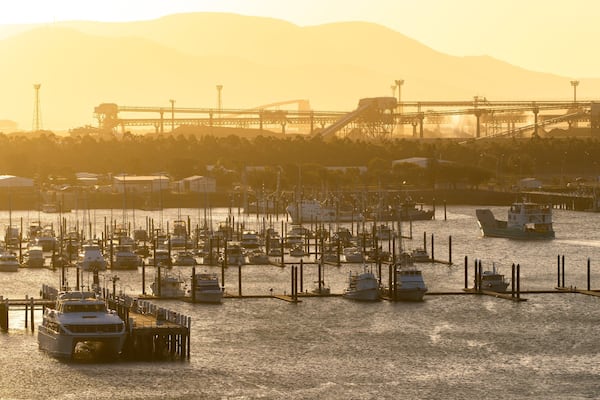 Callemondah which includes a bay or harbor and a sunset