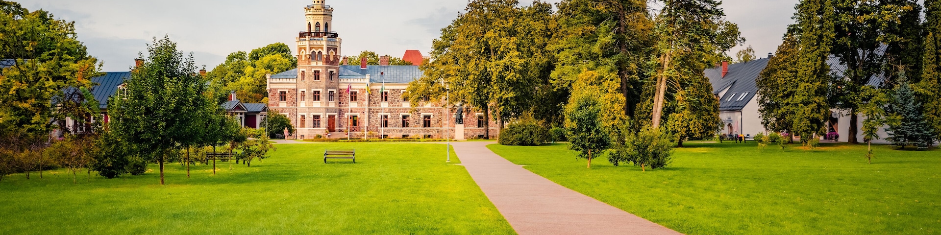 Empty road to old palace. Great morning view of Sigulda New Castle with green meadow and empty tourist path. Colorful summer cityscape Sigulda town, Siguldas novads, Latvia, Europe.