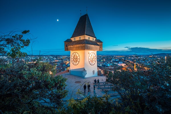 City of Graz with famous clock tower at night, Styria, Austria